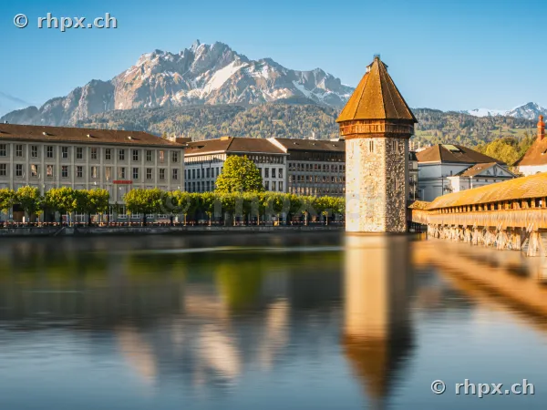 Wasserturm of the Chapel Bridge in Lucerne with Mount Pilatus in sunny weather