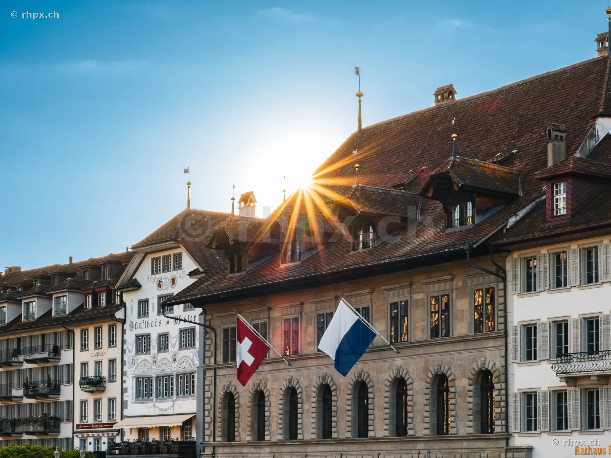 Luzern town hall with sun rays behind the roof gable