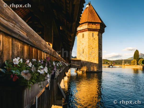 View from the Chapel Bridge in Lucerne towards the Water Tower at sunset