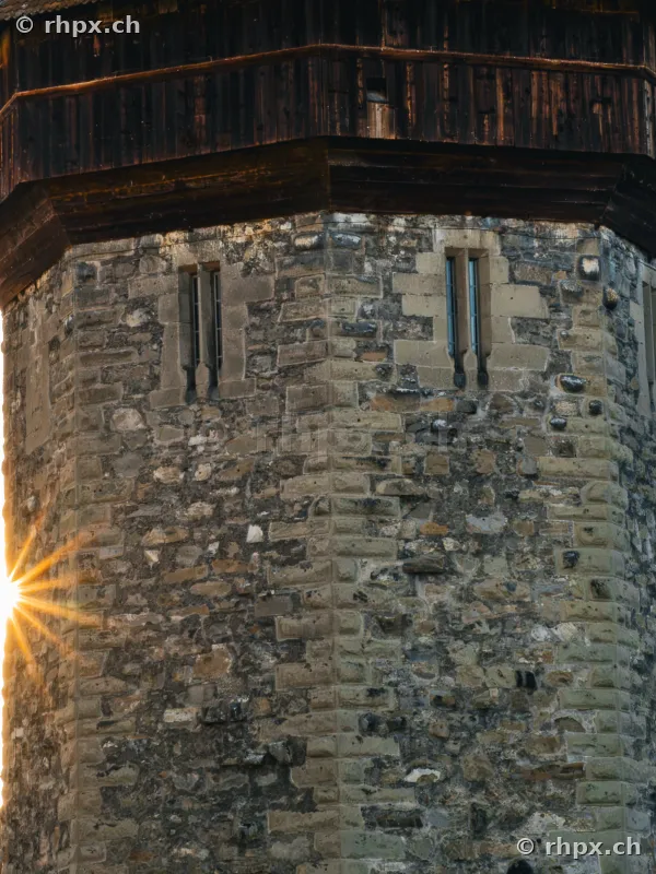 Close-up of the stone Wasserturm of the Chapel Bridge in Lucerne with incoming sunlight