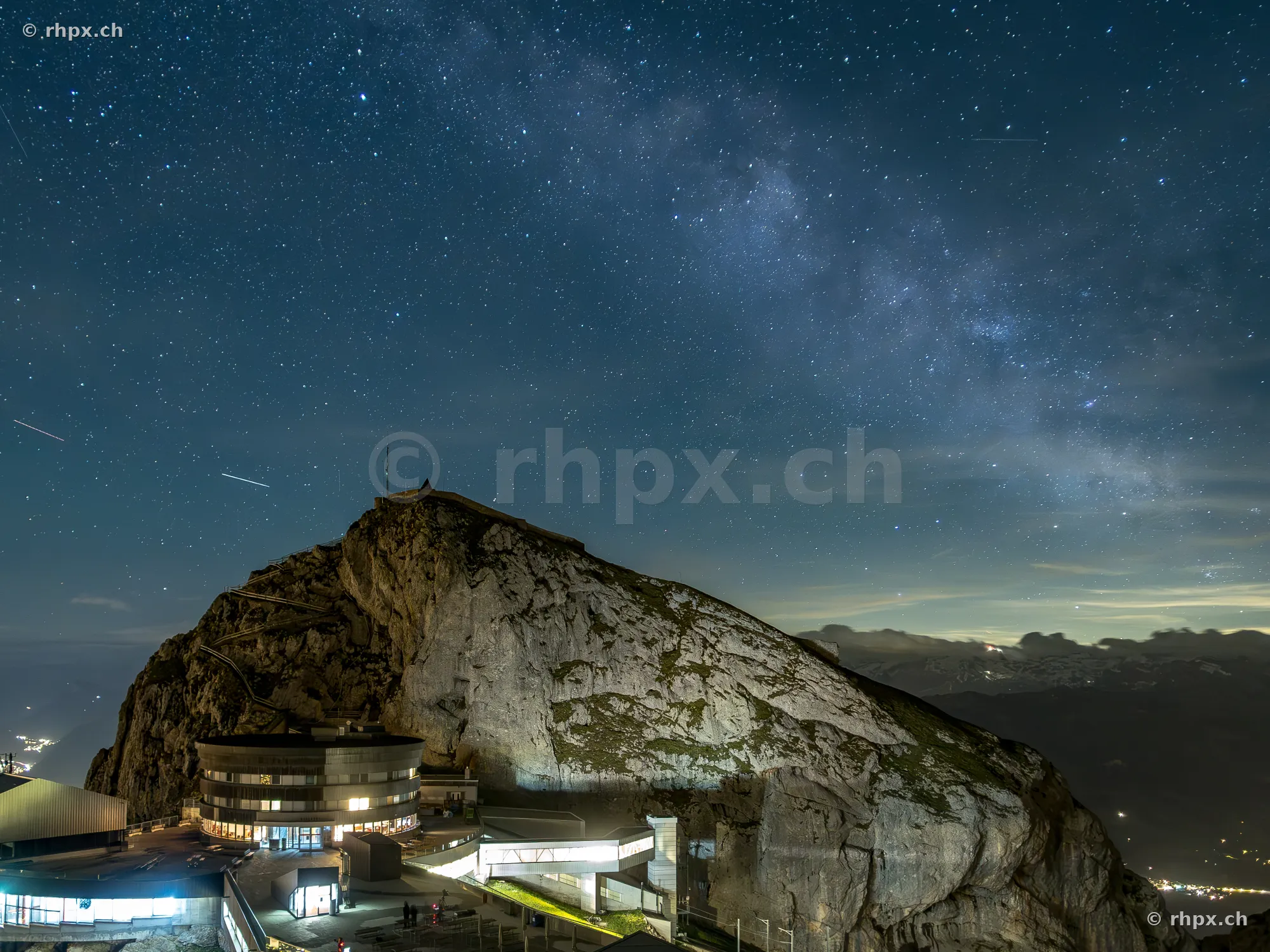 Night view of the Pilatus peak with hotel building under a starry sky