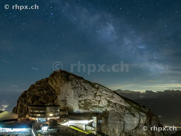Night view of the Pilatus peak with hotel building under a starry sky