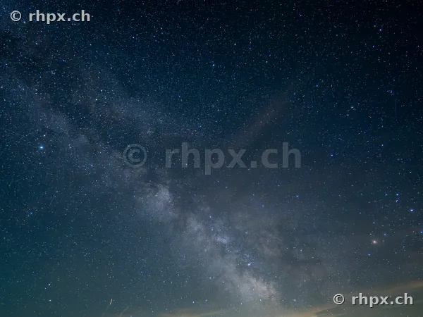 Starry sky with the Milky Way over the dark outline of Mount Pilatus