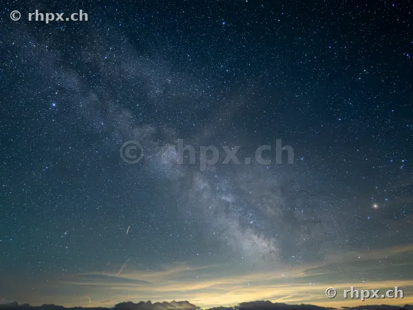 The Milky Way shines brightly above the dark silhouette of Mount Pilatus in Central Switzerland.