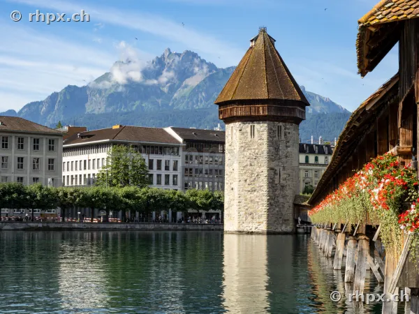 Water Tower and Chapel Bridge in Lucerne with Mount Pilatus in the background