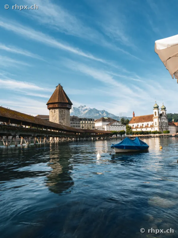 The Chapel Bridge with Water Tower and Jesuit Church in Lucerne during the day