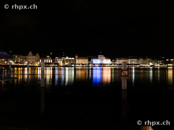 Night view of the illuminated buildings along the waterfront in Lucerne on Lake Lucerne