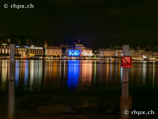 View across Lake Lucerne towards the illuminated waterfront of Lucerne at night
