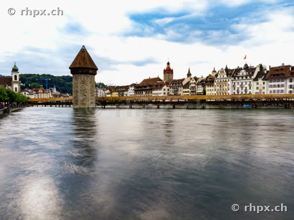 The Chapel Bridge with the water tower over the Reuss river against the backdrop of Lucerne's old town.