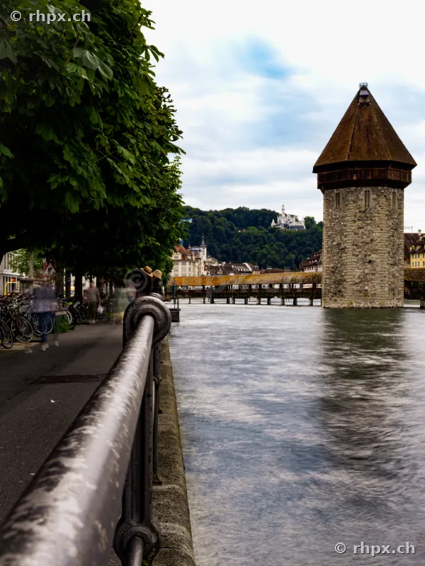 View along the Reuss river towards the Water Tower and Chapel Bridge in Lucerne