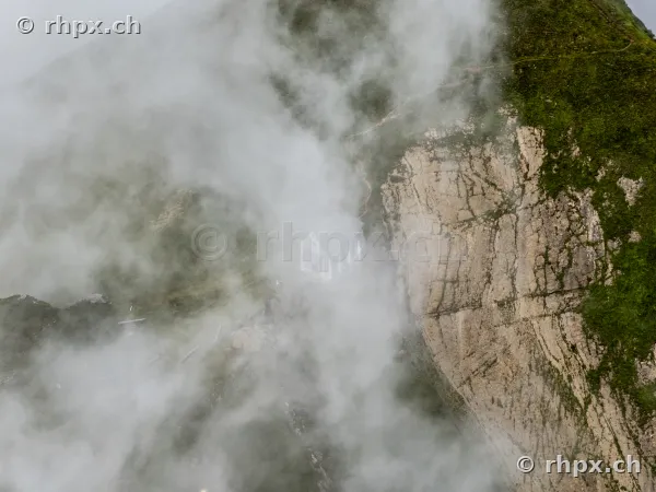 Steep rock face of Mount Pilatus in dense cloudy conditions