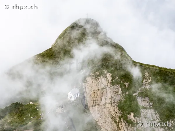 The small chapel on the rocky slope of Mount Pilatus in dense clouds