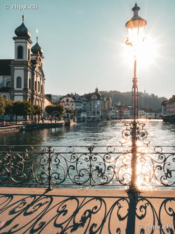 View of the Hofkirche in Lucerne from a bridge during sunset