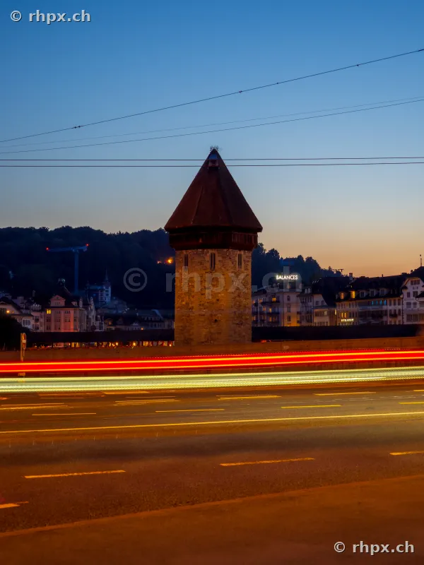 Water Tower in Lucerne with light trails of traffic in front of the evening sky