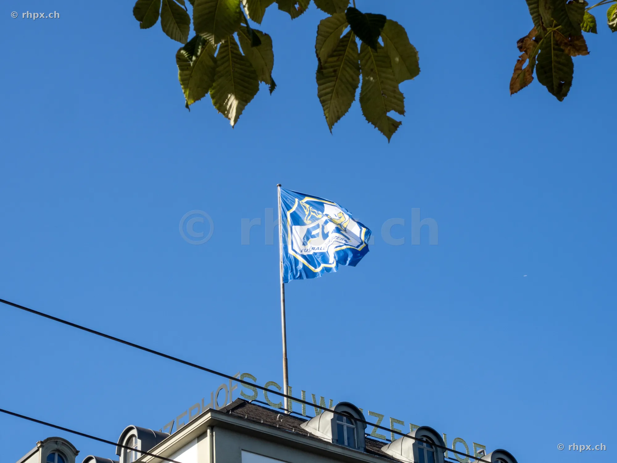 The 125th anniversary flag of FC Luzern flying on the roof of Hotel Schweizerhof in Lucerne.