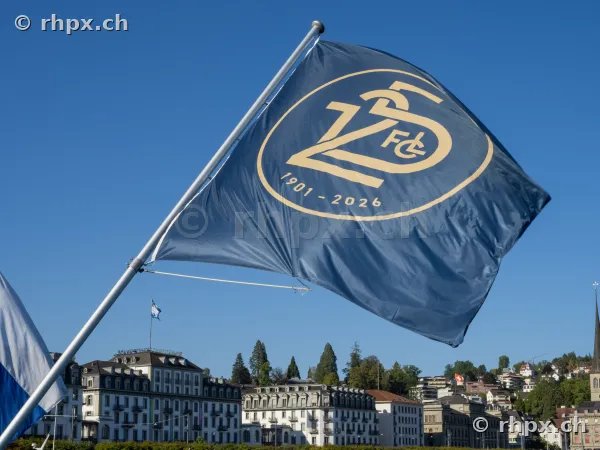 Blue FCL anniversary flag in front of the scenery of Lucerne