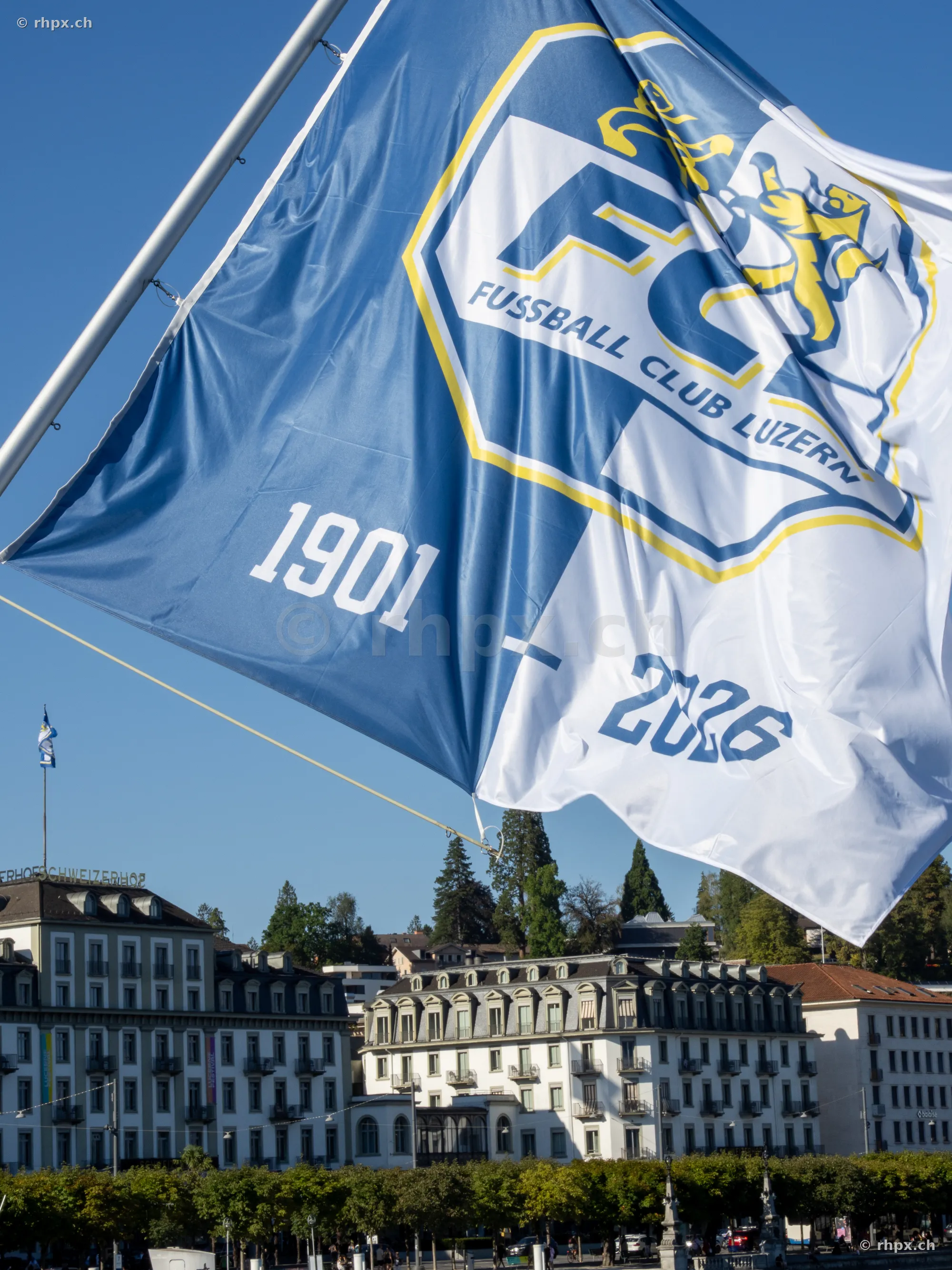Waving anniversary flag of FC Luzern in front of historic buildings in Lucerne