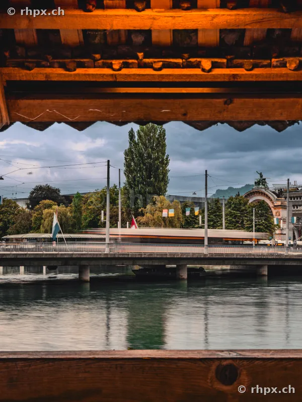 View through the wooden roof of the Chapel Bridge at the Seebrücke in Lucerne with a passing bus