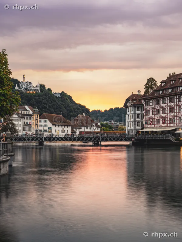 View of the Reuss river with Spreuer bridge and Chateau Gütsch in Lucerne at dusk