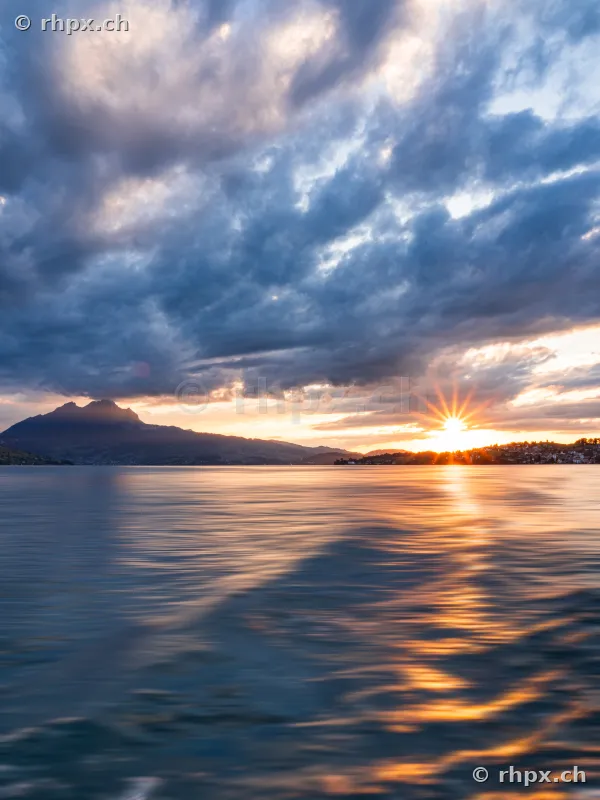 View across Lake Lucerne towards Mount Pilatus at sunset