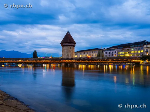 Chapel Bridge with Water Tower in Lucerne at twilight with reflections in the Reuss river