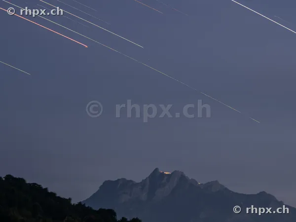 Long exposure of star trails above the dark Mount Pilatus massif in Central Switzerland.