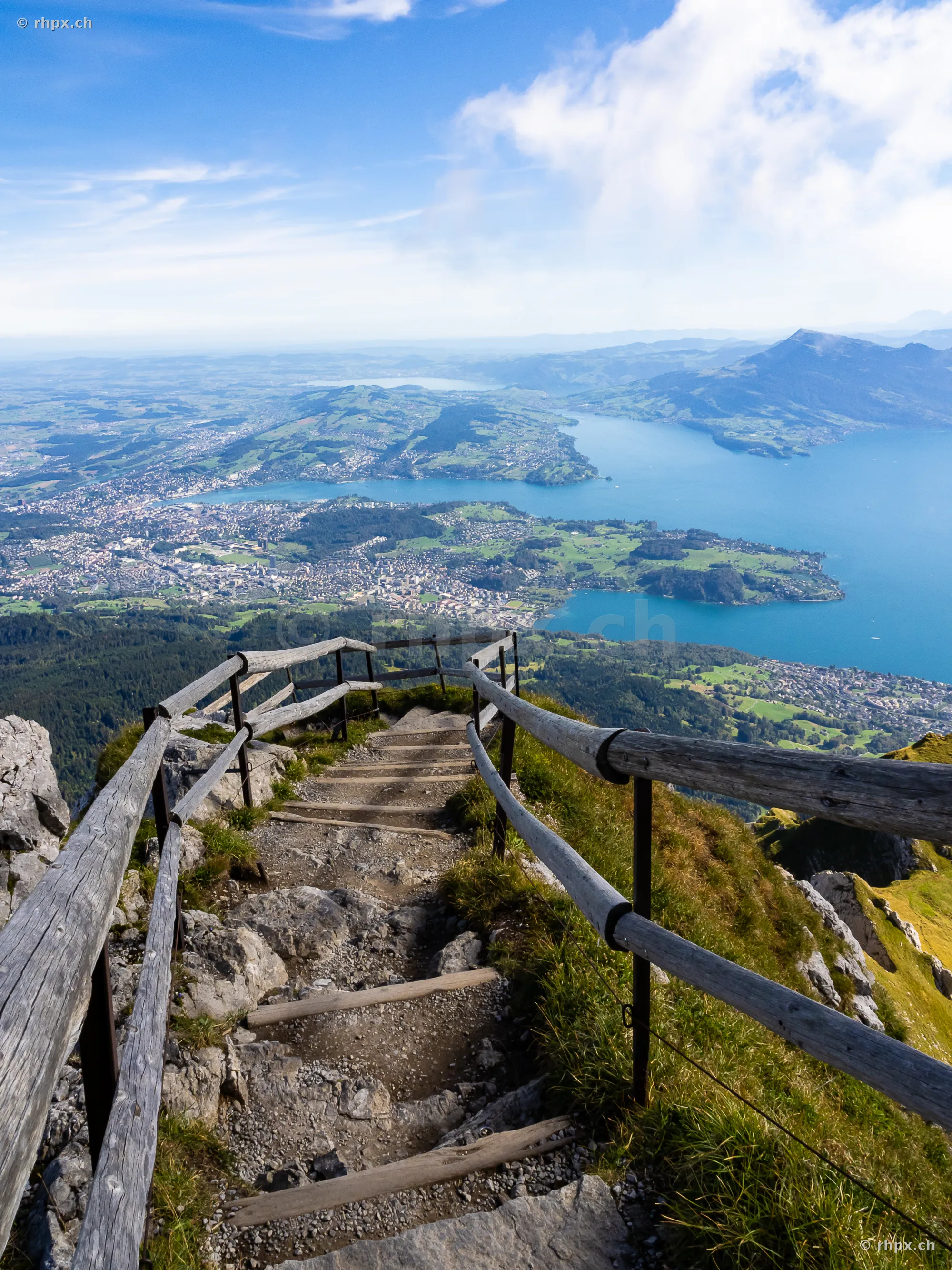 Steep wooden staircase on Mount Pilatus overlooking Lake Lucerne and Central Switzerland