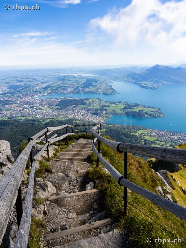 Steep wooden staircase on Mount Pilatus overlooking Lake Lucerne and Central Switzerland