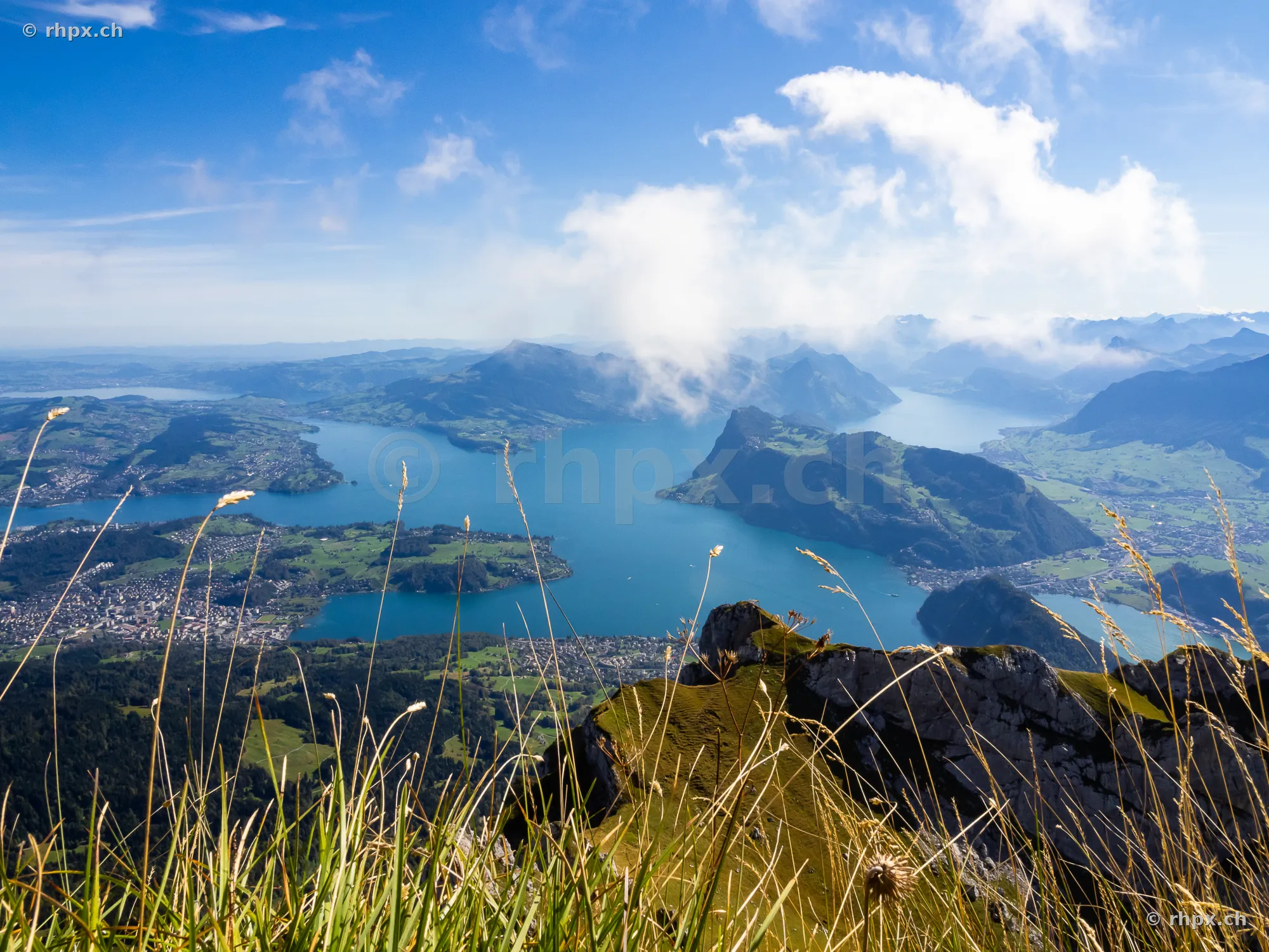 View from the rocky edge of Mount Pilatus over Lake Lucerne and surrounding mountains