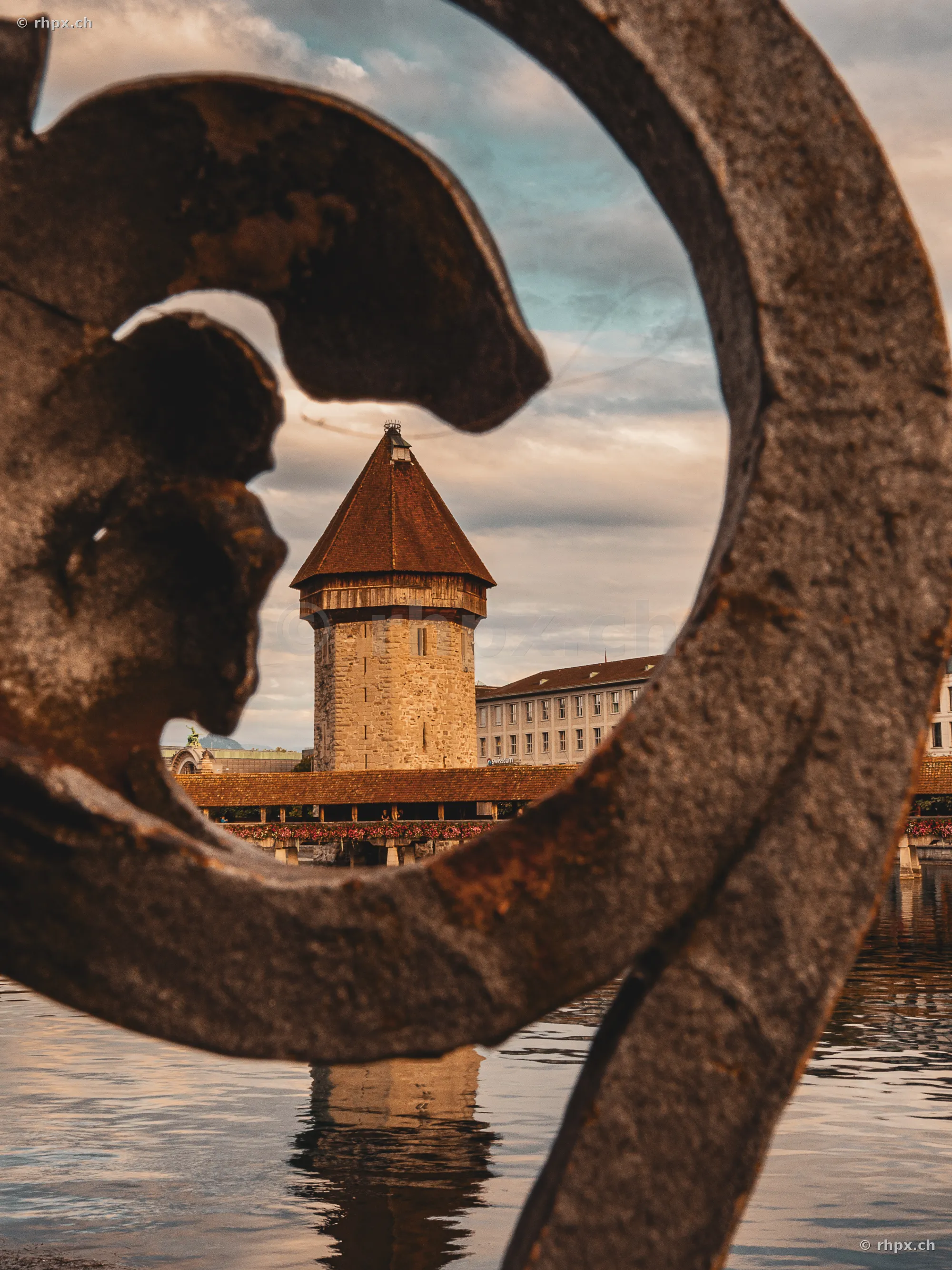 Blick auf den Wasserturm Luzern durch eine metallene Verzierung