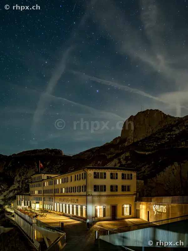 Night view of the Hotel Pilatus-Kulm under a clear starry sky