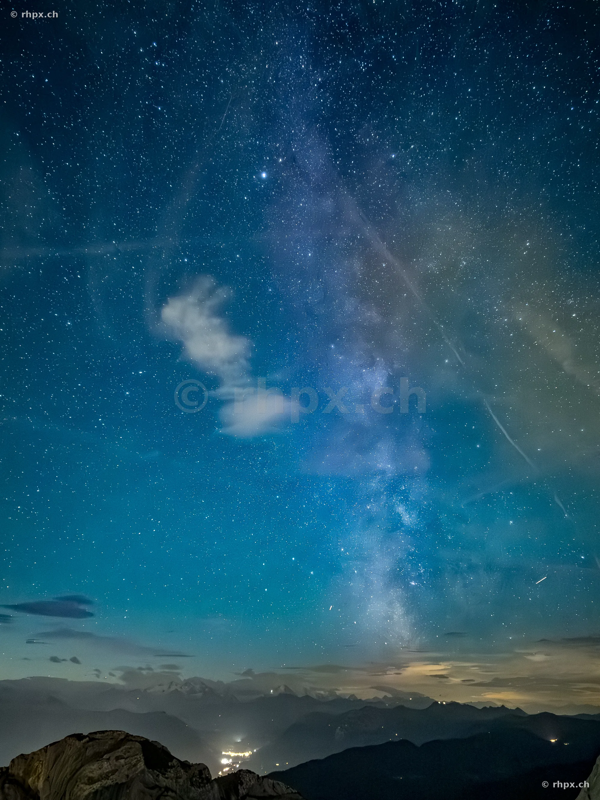 View of the Milky Way and starry sky over the Pilatus mountains at night.