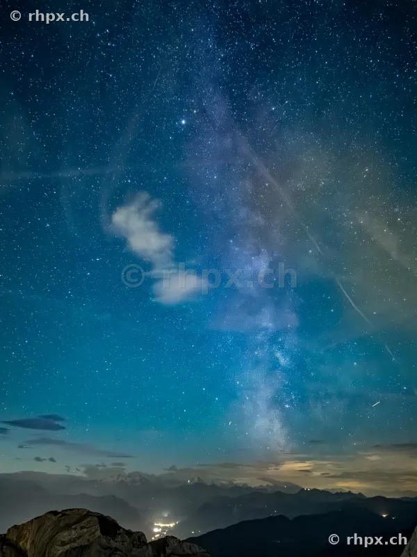 View of the Milky Way and starry sky over the Pilatus mountains at night.