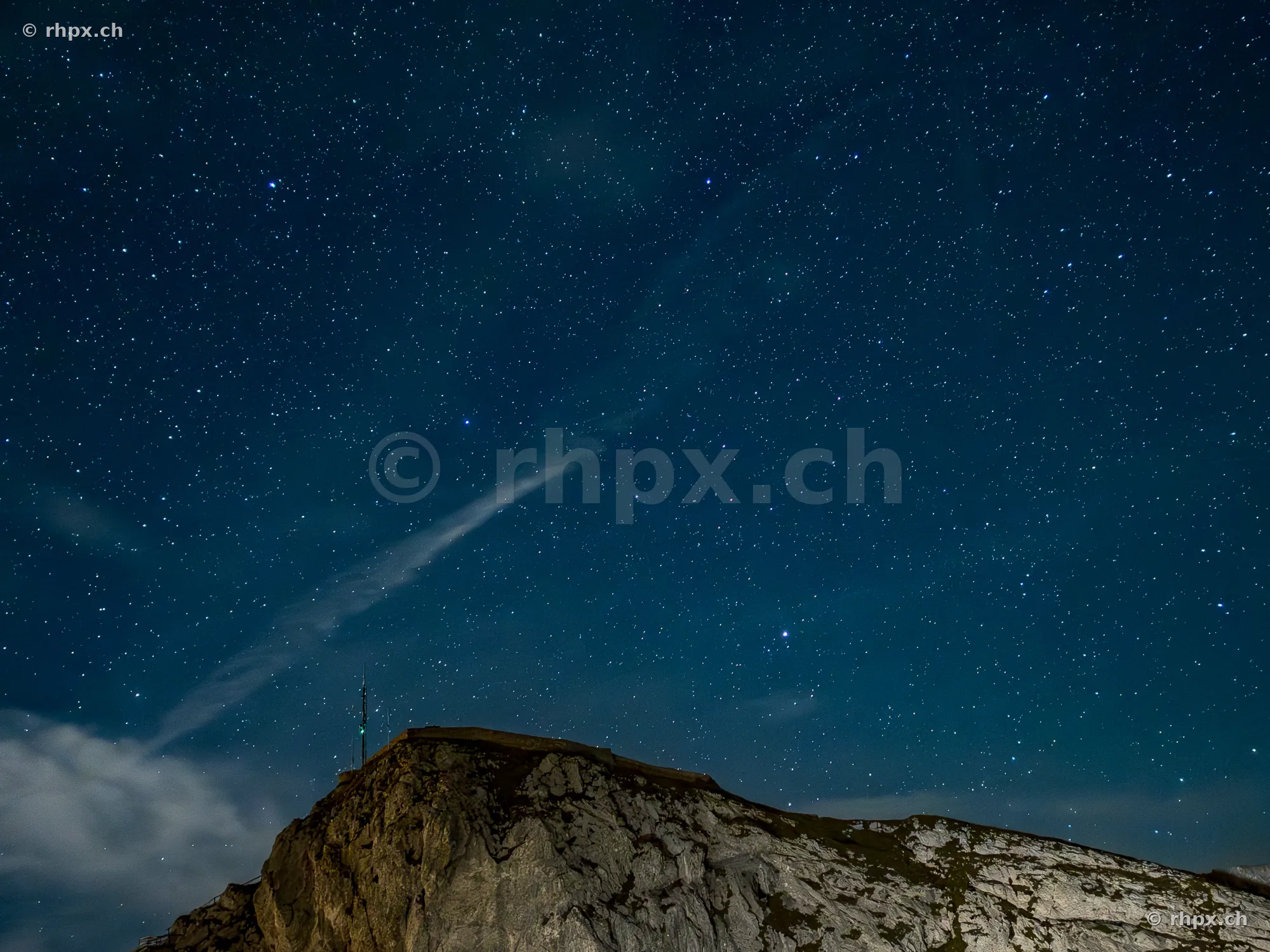 The rocky summit of Mount Pilatus at night under a clear starry sky