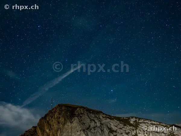 The rocky summit of Mount Pilatus at night under a clear starry sky