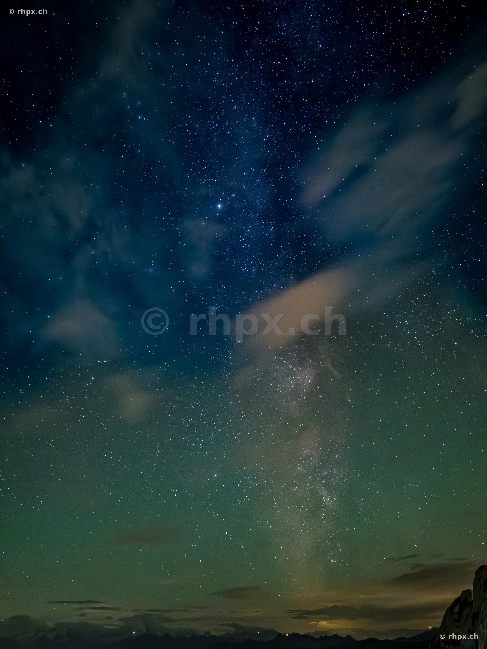 Starry sky and Milky Way above the silhouette of Mount Pilatus at night