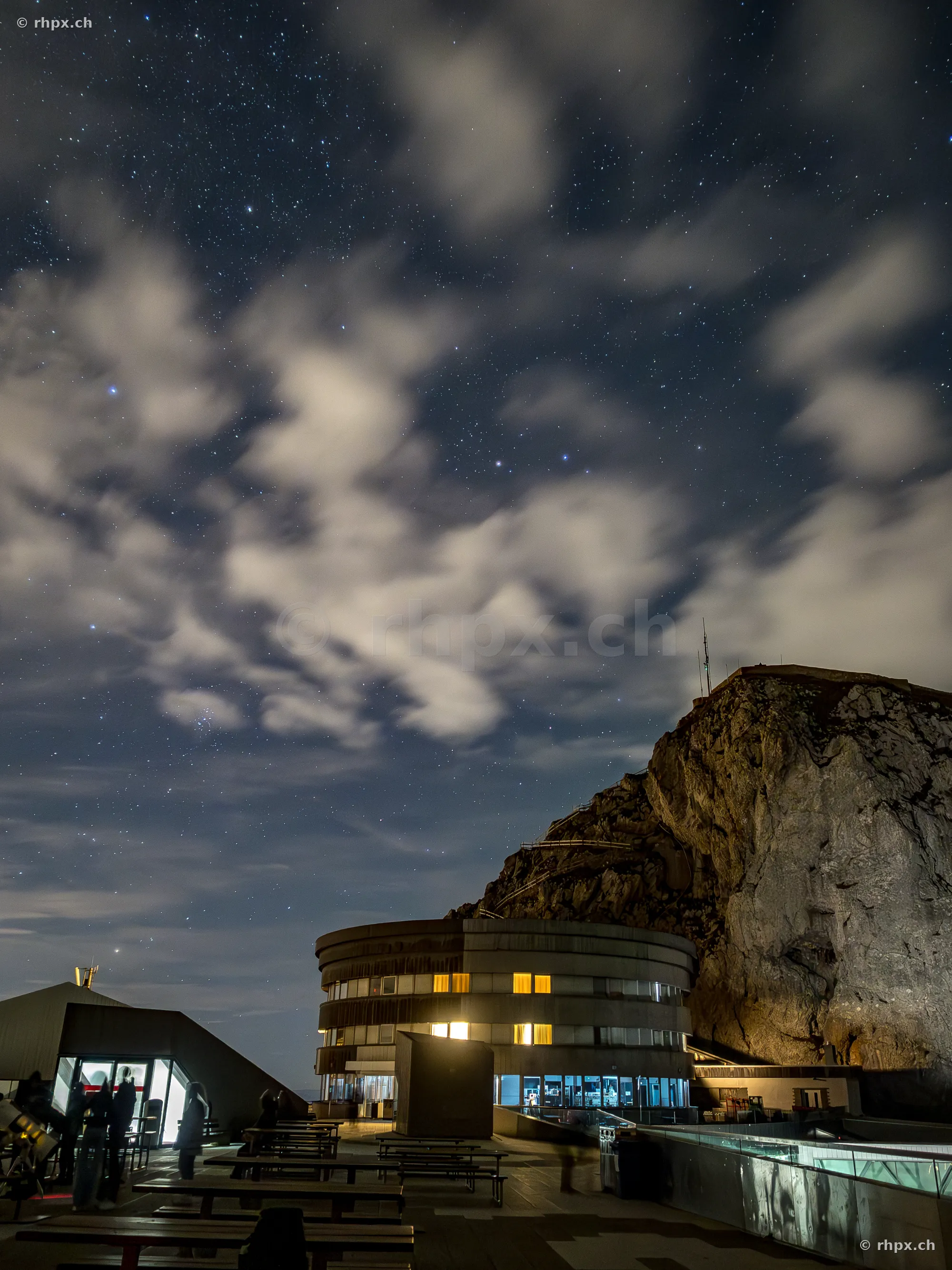 Hotel Bellevue and rock formation at Mount Pilatus at night with starry sky