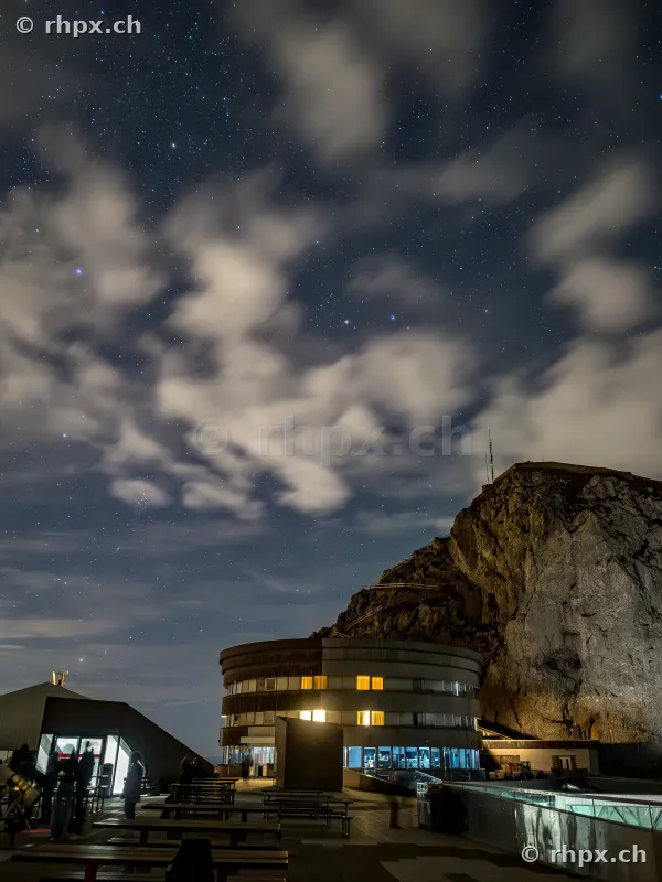 Hotel Bellevue and rock formation at Mount Pilatus at night with starry sky