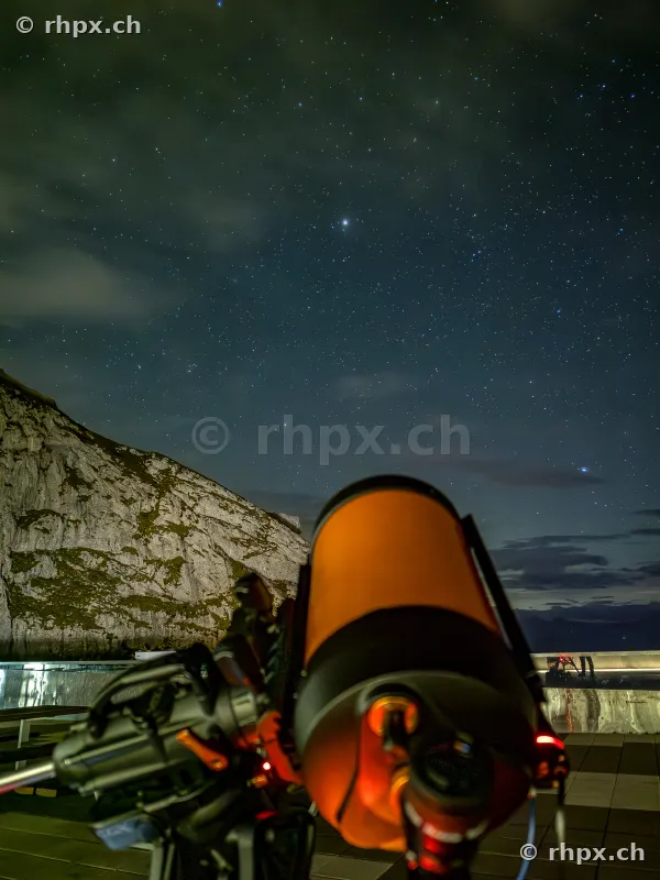 View through a telescope at the night sky on Mount Pilatus