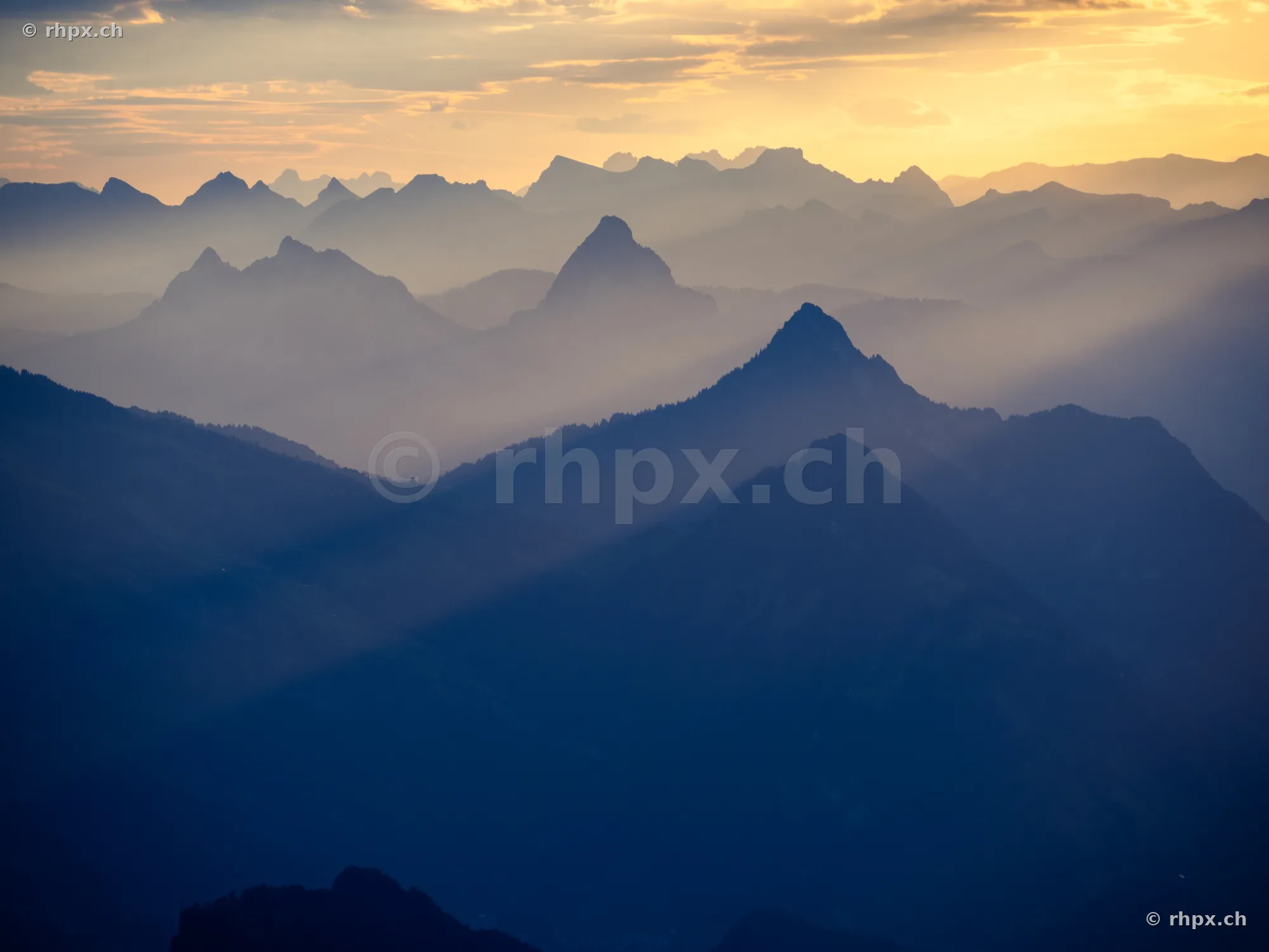 View of the silhouette of the Pilatus mountain range in soft evening light