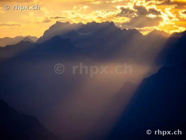 Silhouette of the Pilatus massif in evening backlight with sunbeams