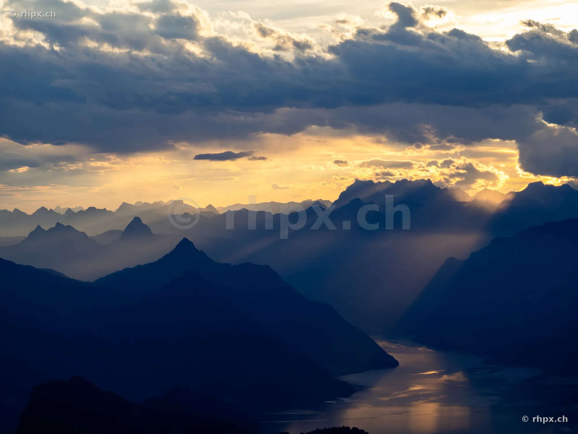 View of the silhouette of Mount Pilatus and Lake Lucerne at sunset