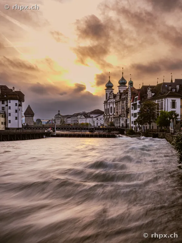 View of the Reuss river with the Jesuit Church in Lucerne at dusk