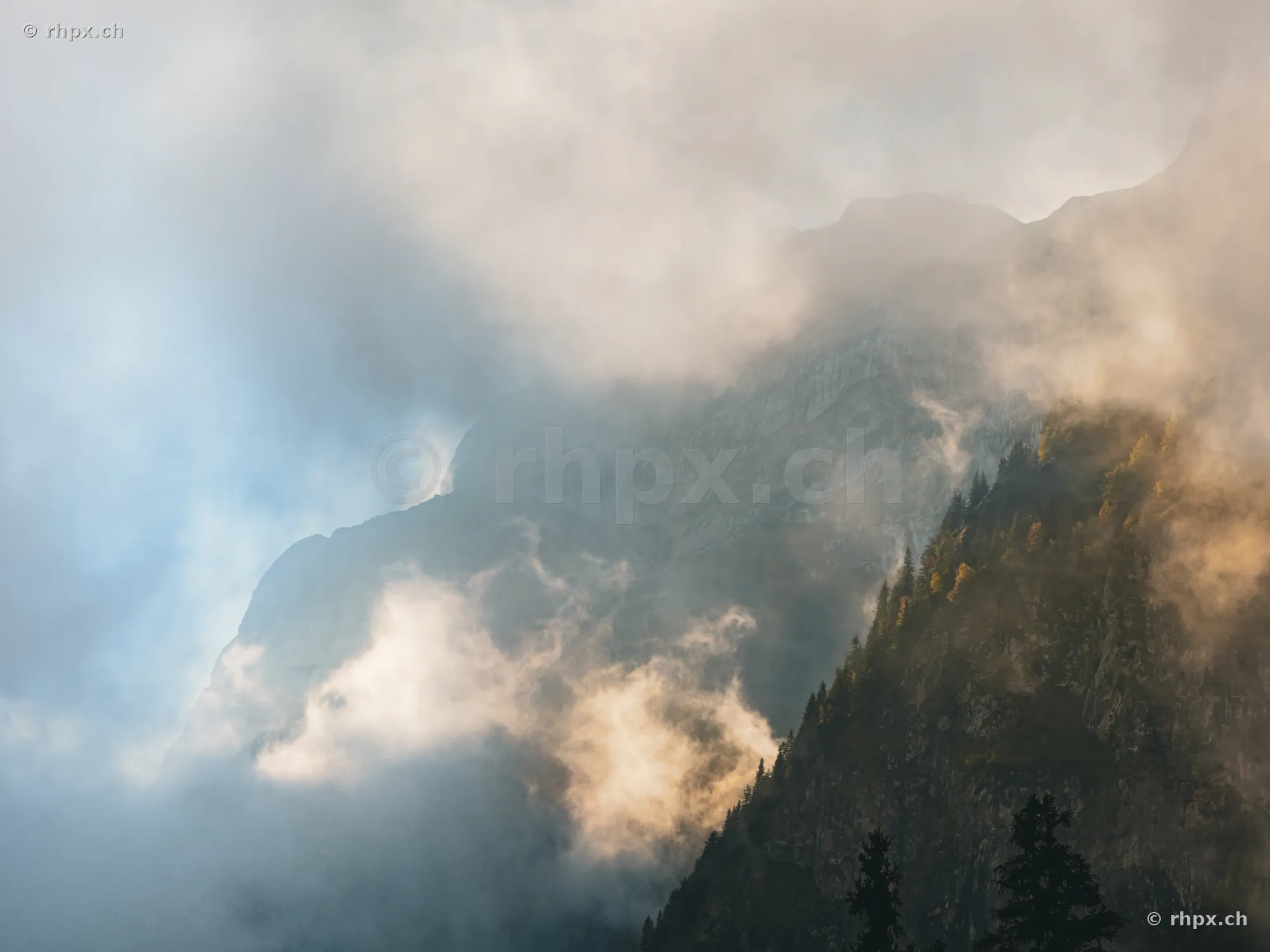 View of the misty, cloud-covered rock faces and forest areas of Mount Pilatus