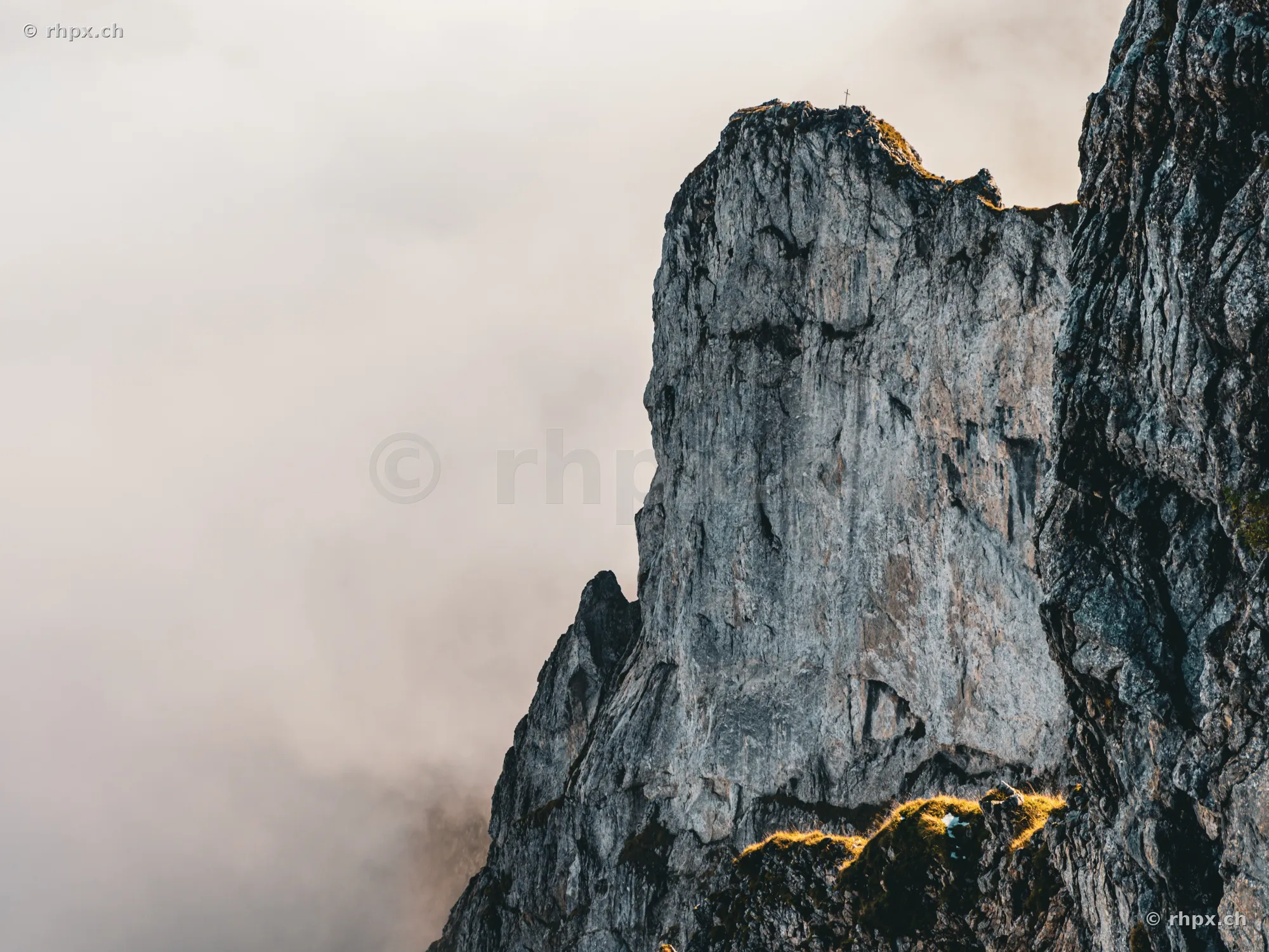 Steep rock face at Mount Pilatus, surrounded by dense fog.
