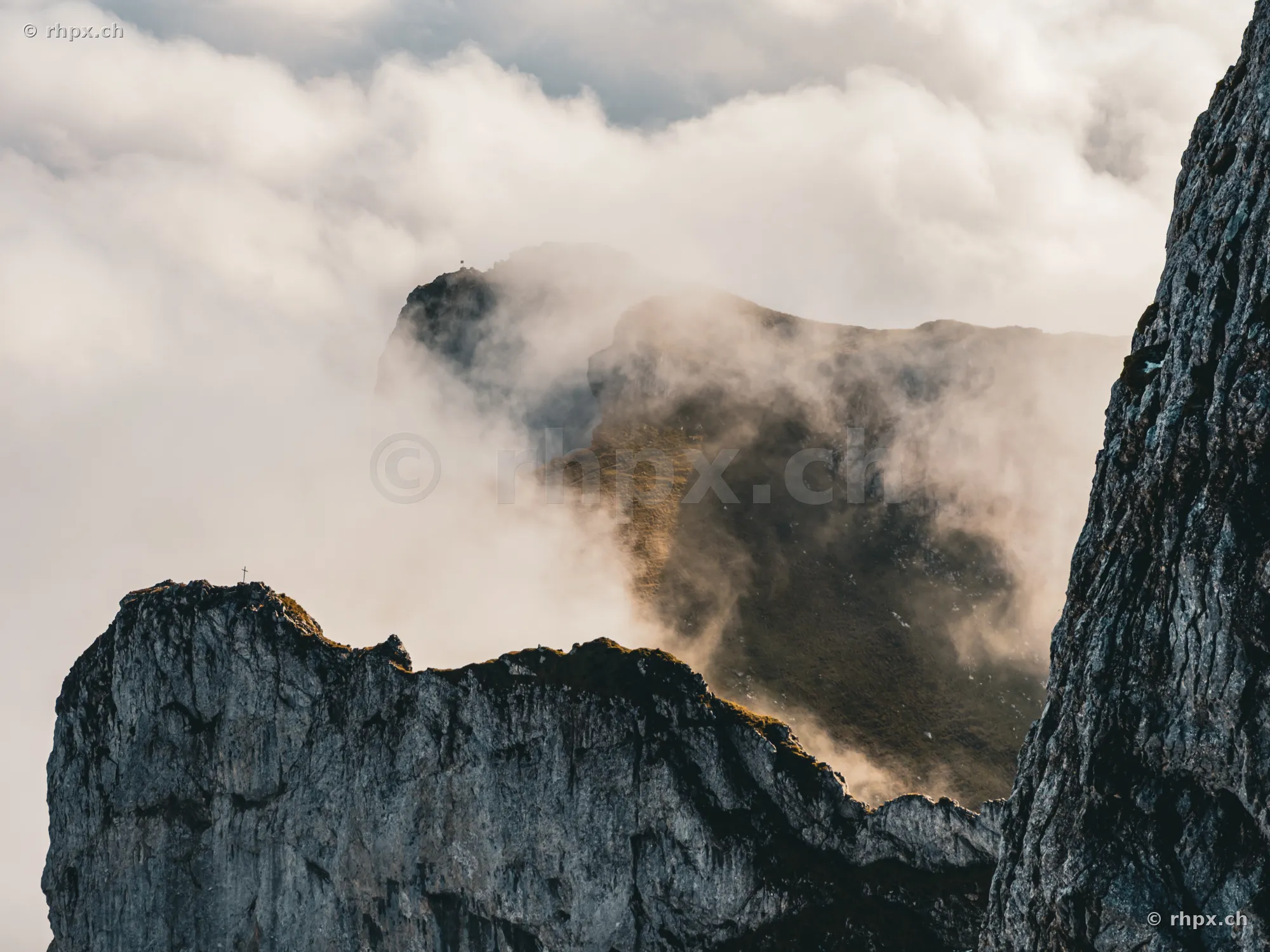 Rock formations of Mount Pilatus in dense fog and clouds