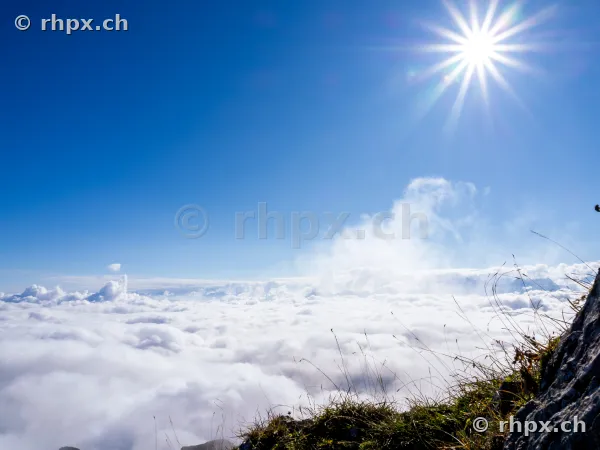 View from Mount Pilatus over a dense sea of clouds in bright sunshine