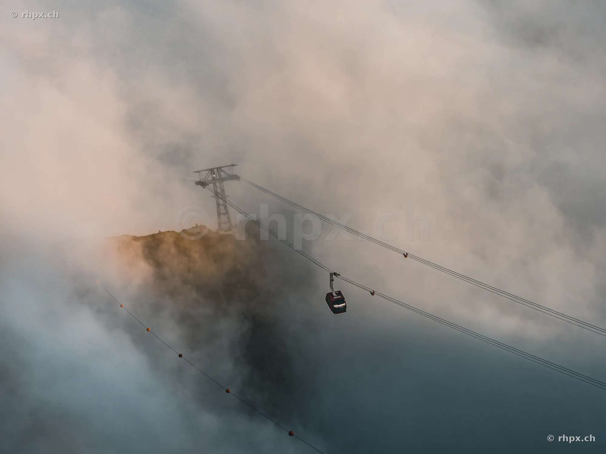 Cable car cabin on Mount Pilatus surrounded by dense fog and rock formations