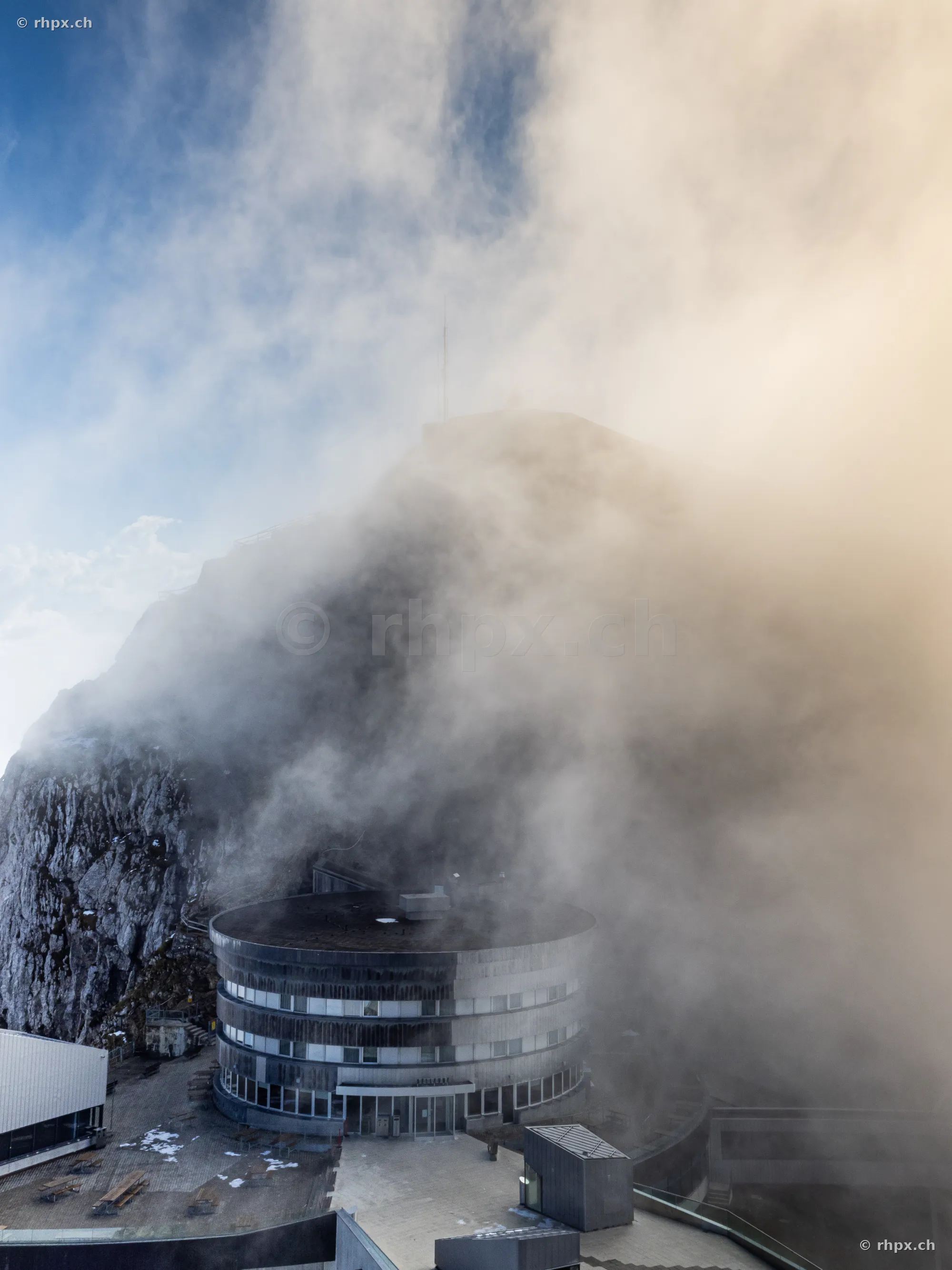 View of Hotel Pilatus-Kulm with dense fog at the summit