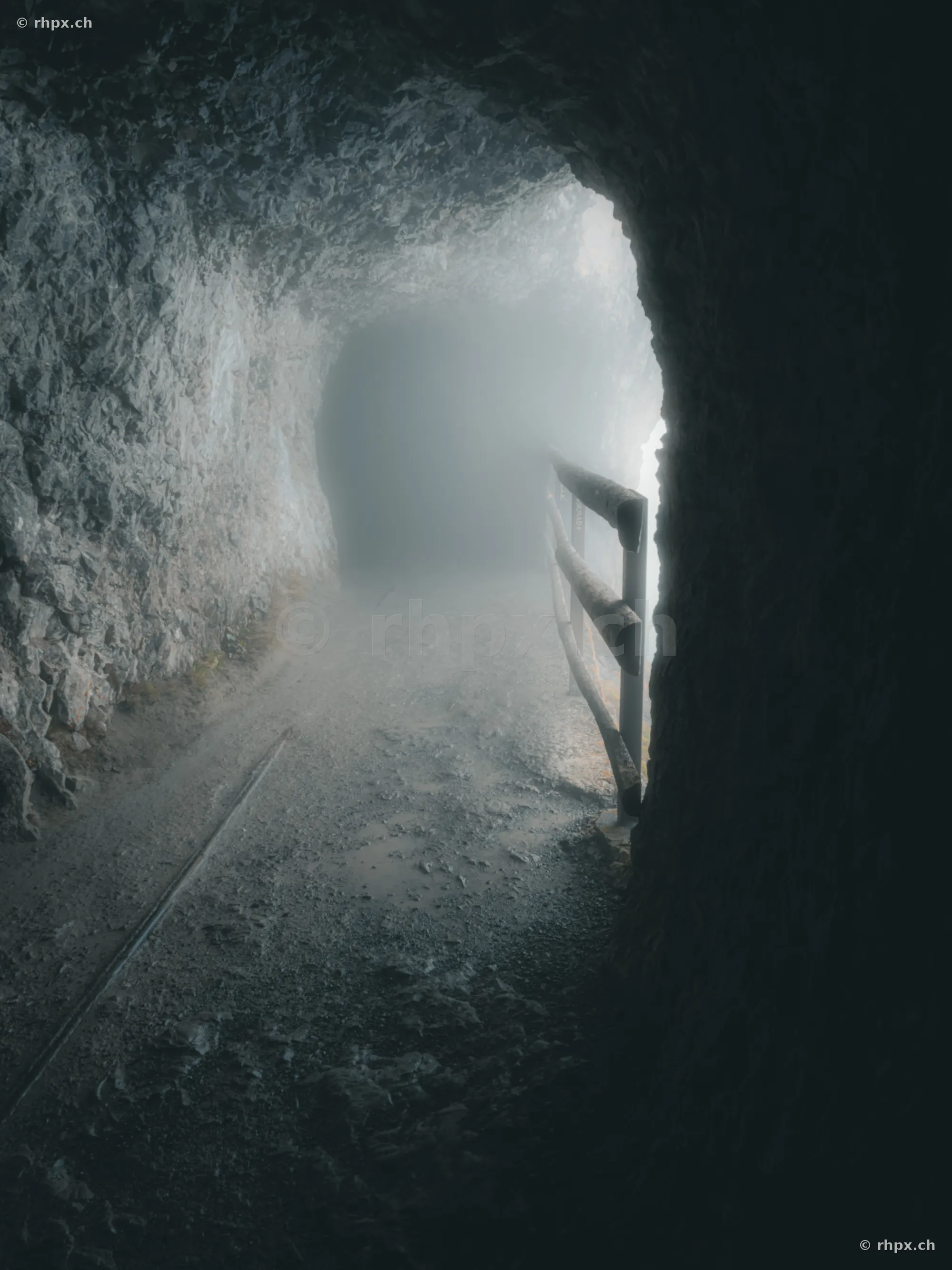 Rocky path in the Dragon Cave on Mount Pilatus with dense fog